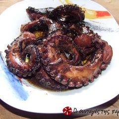 A picture of Octopus with peppers and wine.
