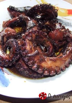 A picture of Octopus with peppers and wine.