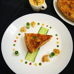 A picture of Nawabi veg musallam with laccha paratha tart.