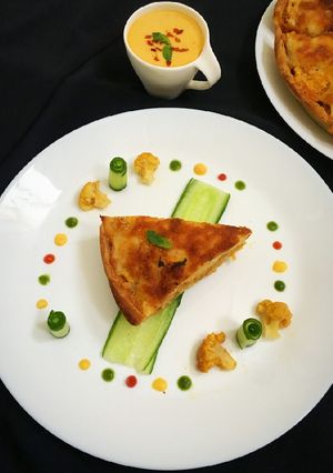 A picture of Nawabi veg musallam with laccha paratha tart.