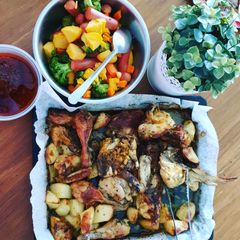 A picture of Roasted chicken with baked potato & sausages.