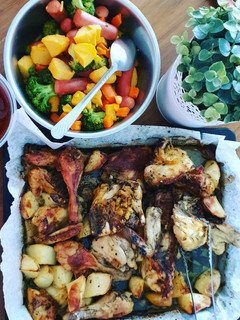 A picture of Roasted chicken with baked potato & sausages.
