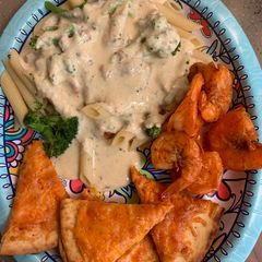 A picture of Bobby&Whittney”s Homemade Penne Chicken Alfredo with broccoli and shrimp.
