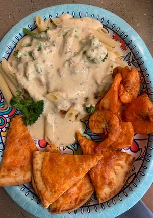 A picture of Bobby&Whittney”s Homemade Penne Chicken Alfredo with broccoli and shrimp.