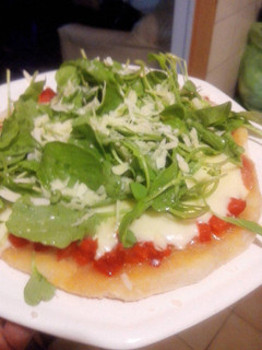 Una foto de Pizza individual con rúcula y parmesano sin horno