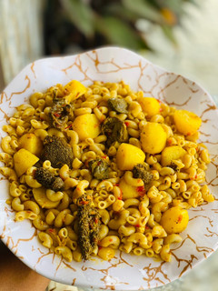 A picture of Macaroni jollof with potatoes.