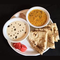 A picture of Dhuli Urad Dal OR Lauki Raita.