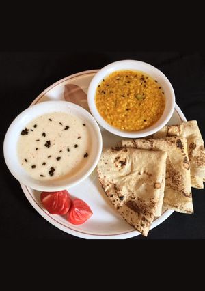 A picture of Dhuli Urad Dal OR Lauki Raita.