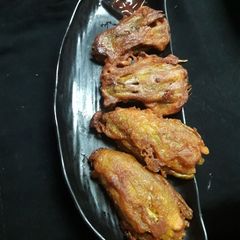 Potoler pakora coded in flour A picture of Potoler pakora coded in flour.