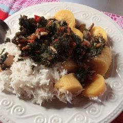 A picture of White rice with boiled plantain and vegetable sauce.