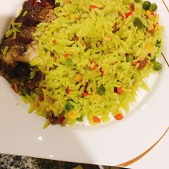 A picture of Fried rice and chicken.