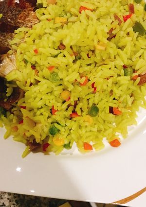 A picture of Fried rice and chicken.