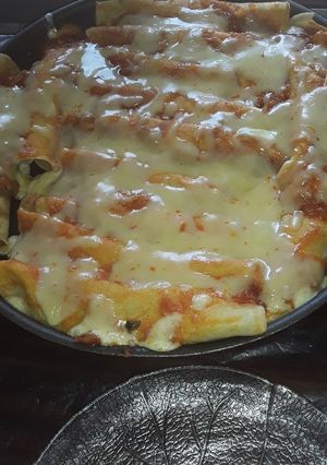 Una foto de Canelones de carne con salsa y queso muzzarella