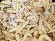 A picture of thin sliced chicken breast with pasta
