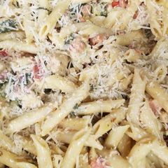A picture of Chicken Bacon Pasta Spinach and Tomatos in garlic cream sauce.