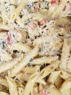 A picture of Chicken Bacon Pasta Spinach and Tomatos in garlic cream sauce.