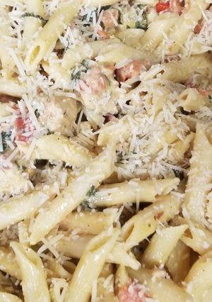 A picture of Chicken Bacon Pasta Spinach and Tomatos in garlic cream sauce.