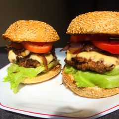 A picture of Juicy homemade burgers-with caramelized onions.