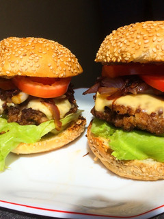 A picture of Juicy homemade burgers-with caramelized onions.