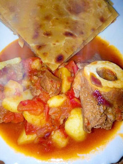 A picture of Beef goulash served with chapati.