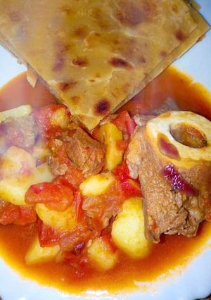 A picture of Beef goulash served with chapati.