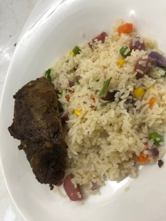 A picture of Chinese stir fry with grilled lamb ribs.