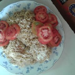 A picture of Noodles and unscrambled cook eggs.