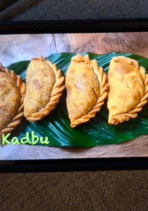 A picture of Kadbu (Sweet Calzones) - 8 Karanji with Puran Stuffing.