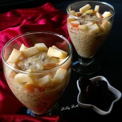 A picture of Dates raisins sabudana kheer served with chunk apples.