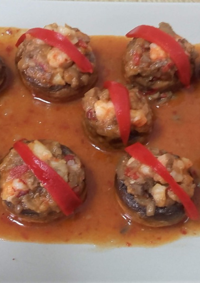 Una foto de Champiñones rellenos de langostinos en salsa picante