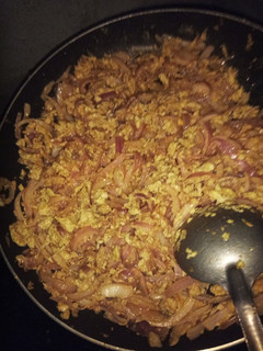 A picture of Scrambled eggs with stir-fry onions.