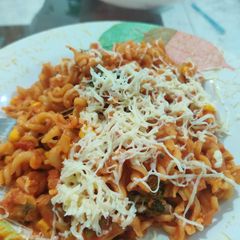 A picture of Penne pasta with cheese.
