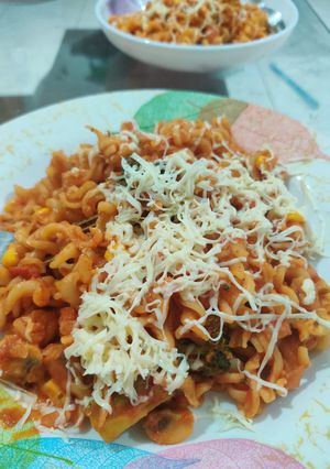 A picture of Penne pasta with cheese.
