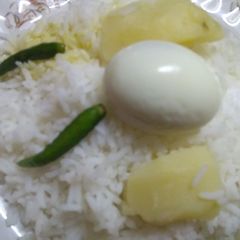 A picture of Boiled rice with egg and Potato.