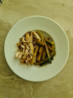 A picture of Shredded chicken with cucumber salad.