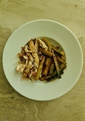 A picture of Shredded chicken with cucumber salad.