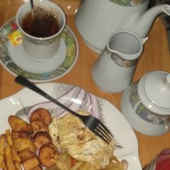 A picture of Fried potatoes, plantain,egg n tea.