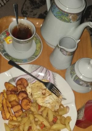 A picture of Fried potatoes, plantain,egg n tea.