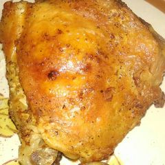A picture of Roasted chicken thighs skin-on .