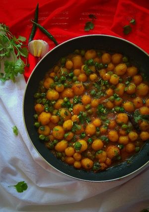 A picture of Baby Potato Curry with Green Peas.