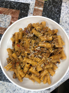 A picture of Rigatoni pasta in minced meat.