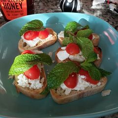 A picture of Toast with feta cheese 🧀 🍅🌱.