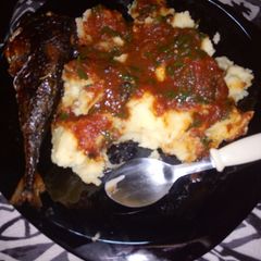 A picture of Mashed potatoes,tomato stew and deep fried fish...