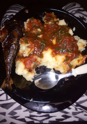 A picture of Mashed potatoes,tomato stew and deep fried fish...