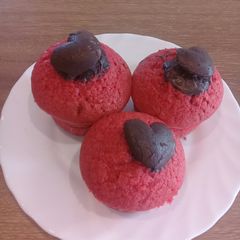 A picture of Vanilla coloured cupcakes with a touch of heart chocolate on top.