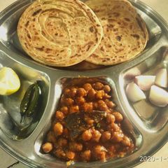 A picture of Pindi chole with laccha paratha.