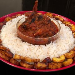 A picture of Rice, assorted stew and plantain.