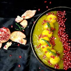 A picture of Mango Chenna dumpling in mango chilli sauce.