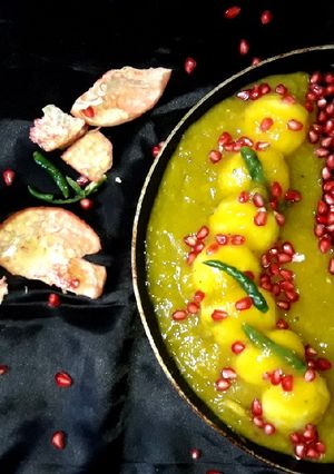 A picture of Mango Chenna dumpling in mango chilli sauce.
