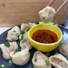 Dumplings served with chilli oil and soya sauce dipping A picture of Dumplings served with chilli oil and soya sauce dipping.